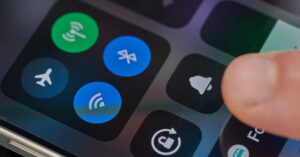 person using drop down control panel on an iPhone accessing Wifi and Bluetooth controls