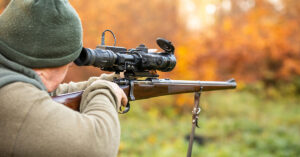 Hunter Kills First Gray Wolf Seen In Lower Peninsula Of Michigan For 100 Years hunter aiming rifle