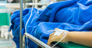 Woman Who Frequently Used E-Cigarettes Had ‘Black Goo Poured Out Of Her Lungs’ Due to Vaping Addiction person in hospital bed