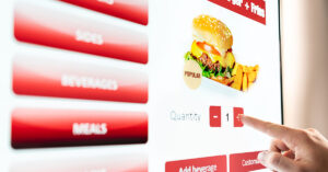 14 Fast-food Item To Avoid Ordering, According to Employees person using touch screen POS to order fast food