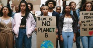 Group of activists with banners protesting to save earth. Men and women rebellions doing a silent protest over global warming and pollution.