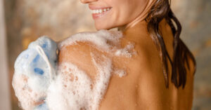 Dermatologist Is Warning Anyone Who Uses a Loofah to Stop For a Really Gross Reason woman using loofah
