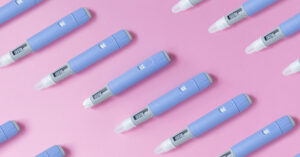 medical drug Ozempic injection lies on a pink background, top view. Medicine and weight loss, concept. injectors dosing pens for subcutaneous injection of antidiabetic medication or anti-obesity