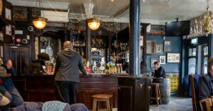man standing at bar