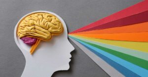 paper cut of a head with paper brain, multicolor prism explosion, rainbow colors, medical and physical, mental, LGBTQ concept