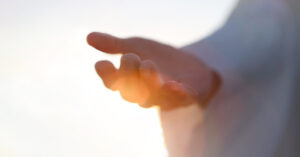 hand placed palm upward with sun shining in background. Christian, Jesus concept