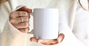 woman holding a white mug