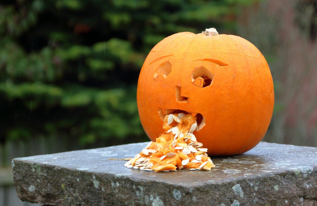 a carved pumpkin throwing up