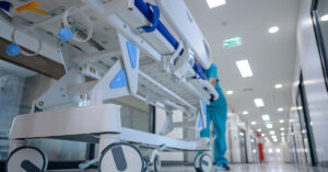 Experts Caution About ‘Hidden’ HMPV Symptoms Often Mistaken for the Flu hospital gurney being shuttled through hallway