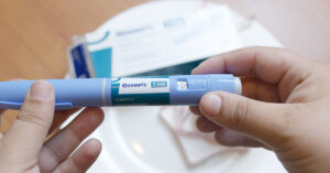 Could Ozempic Be Causing Sudden Blindness? New Research Suggests a Link person holding Ozempic administration pen