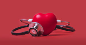 The Top 22 Foods To Avoid for Better Cholesterol Health, According to Experts heart with stethoscope. Heart health concept