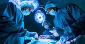 team of surgeons working on a patient in operating room