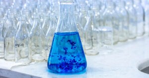 beaker with translucent blue liquid inside. Methylene blue concept