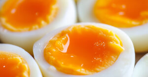 medium soft boiled egg cut in half to reveal yolk