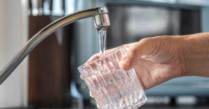 Study Claims IQ Loss From Fluorinated Water Is Significant. Here’s What You Need to Know Glass being filled with tap water