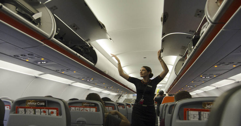 Flight Attendant Reveals Surprising Reason Why Cabin Crew Sits On Their Hands During Take Off and Landing - Featured image