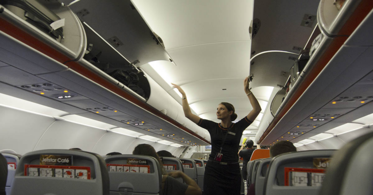 Flight Attendant Reveals Surprising Reason Why Cabin Crew Sits On Their Hands During Take Off and Landing - Featured image