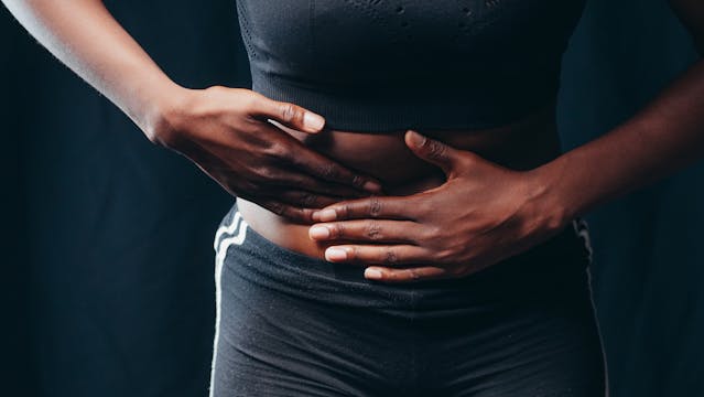person holding stomach in pain