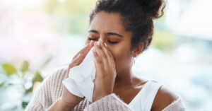 woman blowing nose