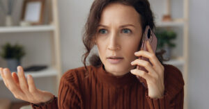 7 Things Debt Collectors Can't Legally Do, Even If You Owe Money woman on phone