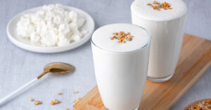a plate of cottage cheese and yogurt based drinks. Fermented food and gut health concept