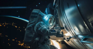 NASA Gives Startling Explanation for Astronauts' Extended Stay in Space astronaut on spacewalk working on the outside of a spaceship