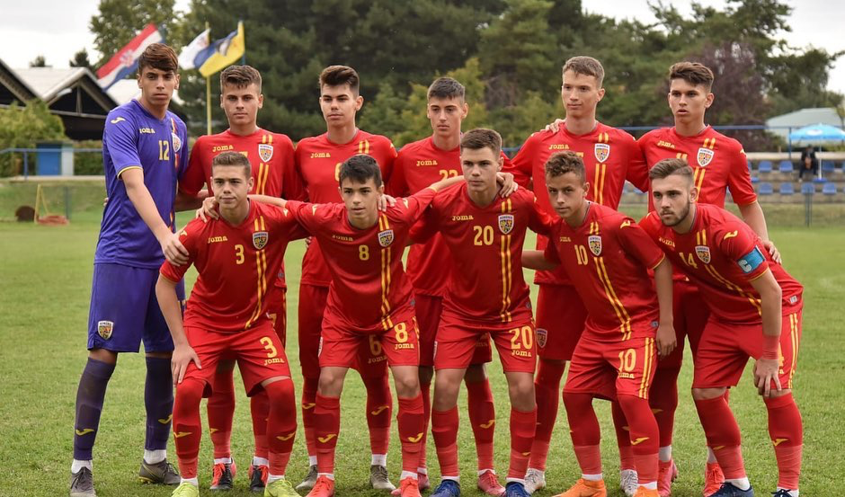 A football team in red uniforms, showcasing 19-year-old Luca Manolache among a group of young men.