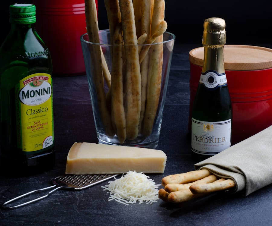 Ingredients for cooking including vine cheese and bread sticks
