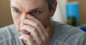 man touching nose/sinus area. Sinus infection concept