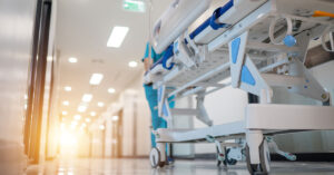hospital staff pushing a gurney down a hallway
