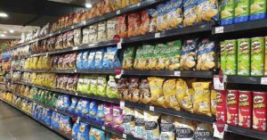 Does Diet Play a Role in Managing ADHD Symptoms in Children? isle at supermarket filled with packaged processed food items like chips and popcorn