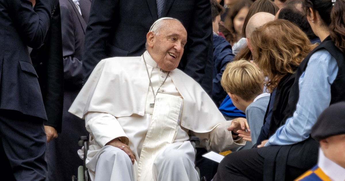 Rome Italy 10 16 2024 Pope Francis smiling while interacting with a child in a wheelchair during a public audience in Vatican City surrounded by people faith inspiration Catholic leader humanity hope