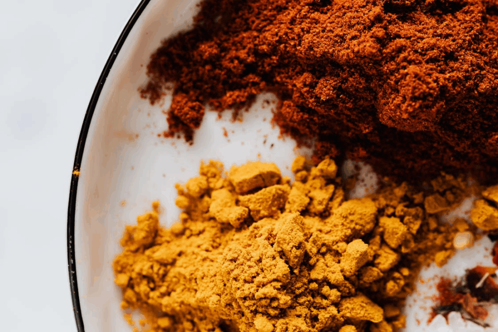 Assorted ground spices in metal bowl