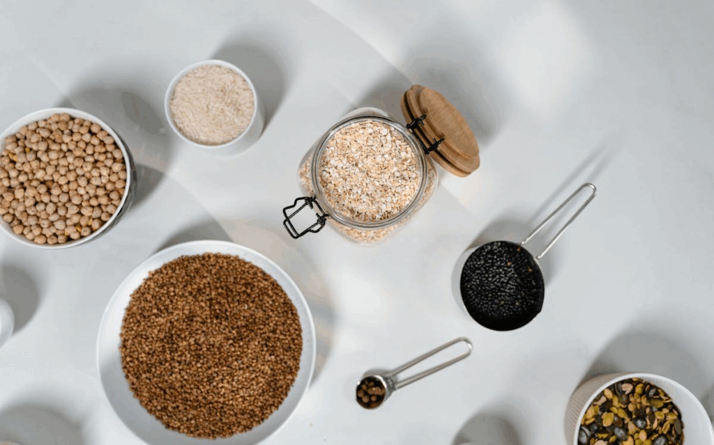 Grains in Containers on a White Surface