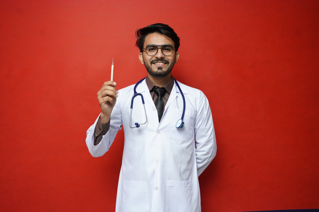 Healthcare professional in a white coat with stethoscope holding a syringe against a red background, representing medical care and birth control services.