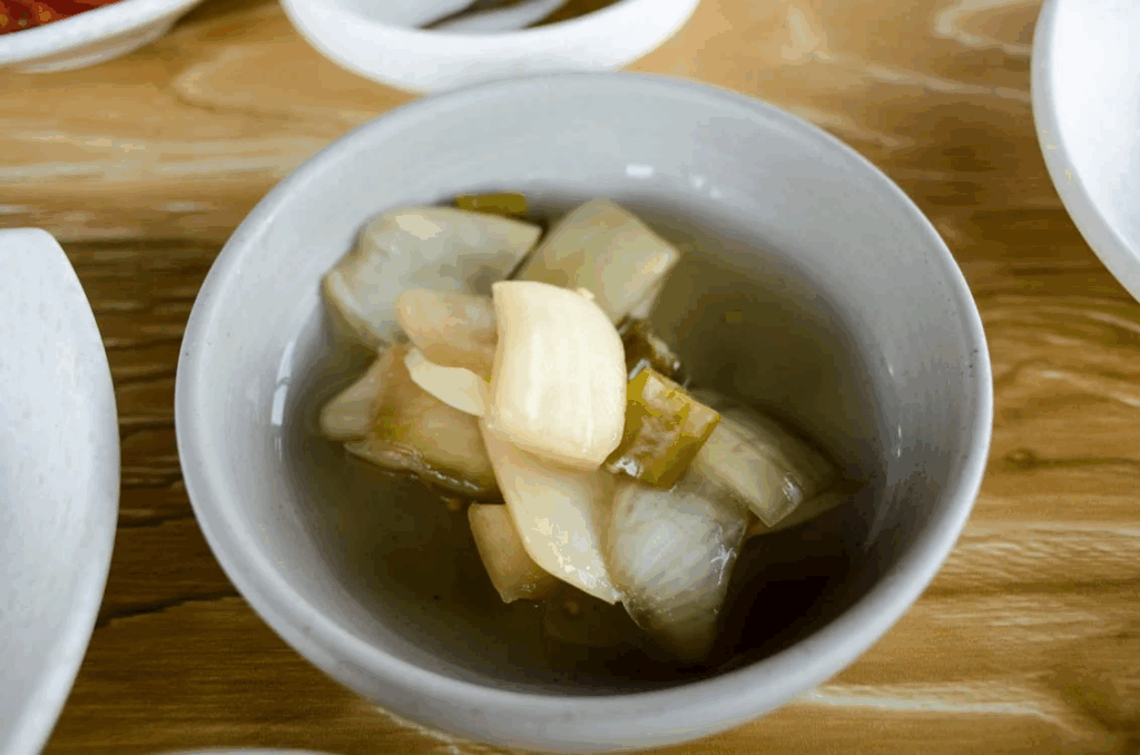 A Bowl of Soup with Fish Meat and Vegetables