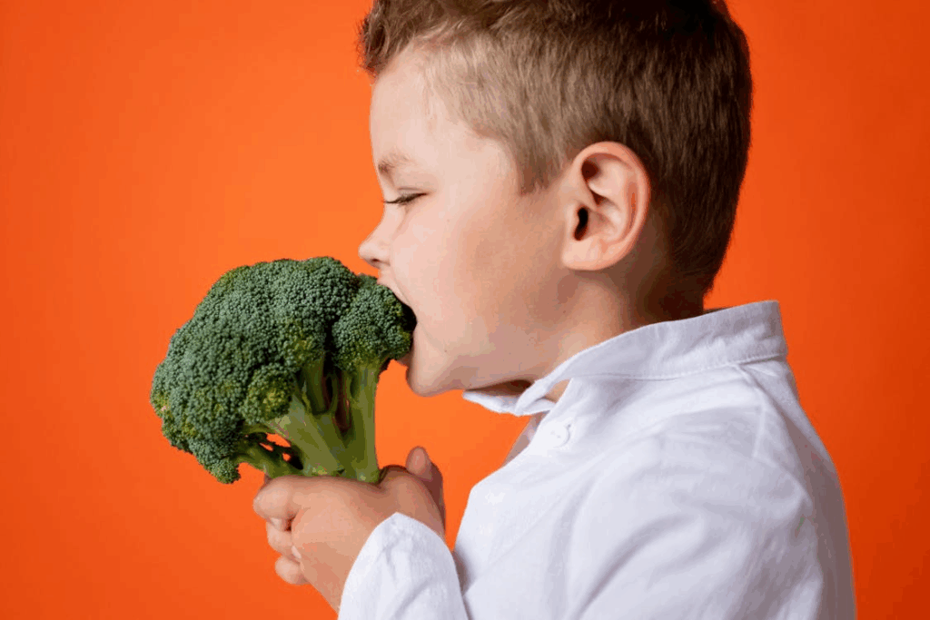 Boy in White Dress Shirt Holding Green Vegetable