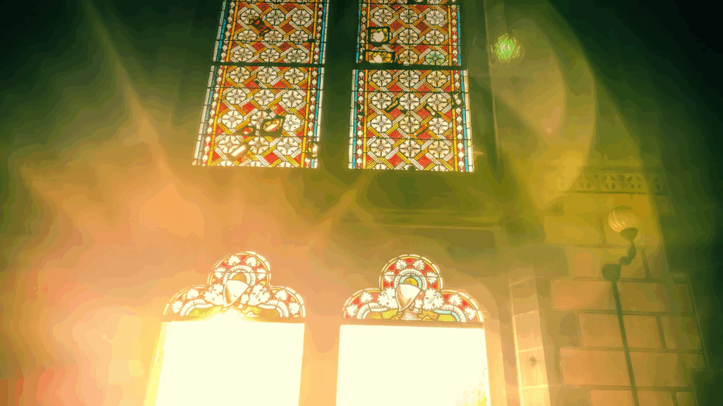 Ornate stained glass windows bathed in warm golden light with visible smoke or mist, representing the surge of electrical activity in the dying brain that may create vivid sensory experiences similar to those reported in near-death accounts.