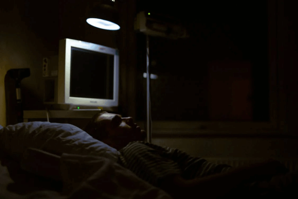 A darkened hospital room with medical monitoring equipment and a patient in bed, illustrating the clinical setting where researchers have discovered continued brain activity for up to ten minutes after the heart stops beating.