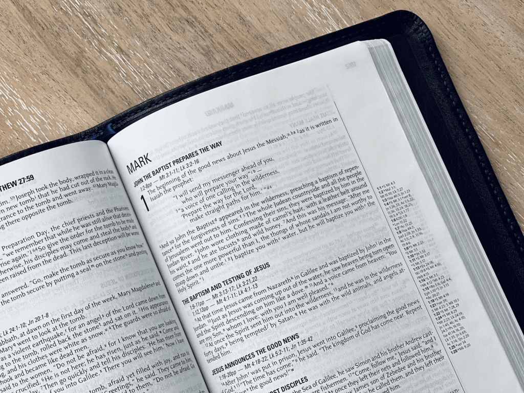 Open Bible showing the beginning of the Gospel of Mark, connecting the archaeological evidence to the sacred text that records these historical individuals whose existence has been validated by discoveries mentioned throughout the article.