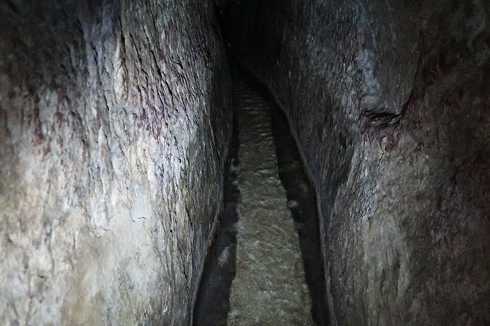 Interior view of Hezekiah's Tunnel, the ancient water channel carved through solid rock beneath Jerusalem in the 8th century BCE. This remarkable engineering achievement, mentioned in 2 Kings and discovered in 1880, confirms King Hezekiah's preparations for the Assyrian siege and provides tangible archaeological evidence of his reign.