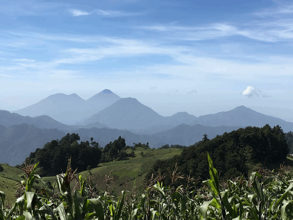 Mountain landscape view of Guatemala showing the terrain near Lake Atitlán where the former eco-resort owners relocated after leaving Sweden. The picturesque setting represents their new venture location after abandoning their previous business.