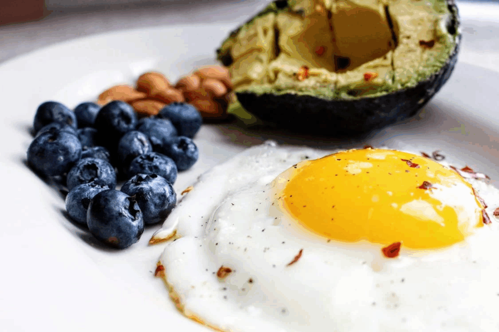 eggs on plate with avocado and blueberries