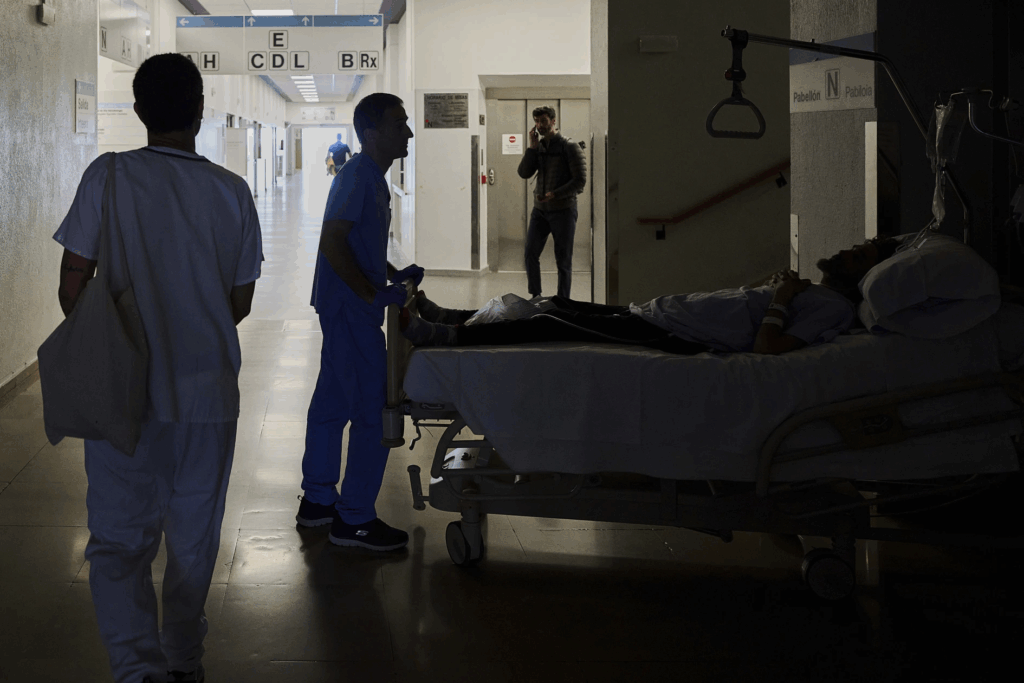 A medical staffer relocates a patient during a the Spain and Portugal blackout