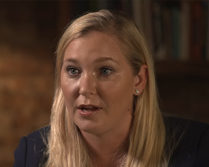 Virginia Giuffre speaking during an interview with a serious expression, highlighting her role as a prominent advocate against sex trafficking.