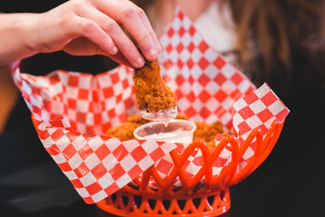 woman eating chicken