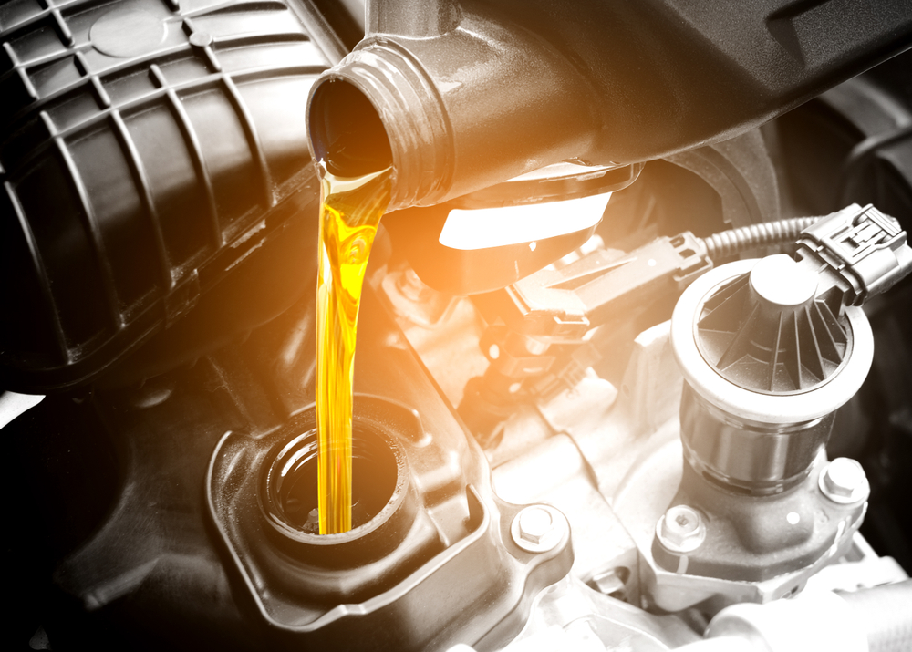 Refueling and pouring oil quality into the engine motor car Transmission and Maintenance Gear .Energy fuel concept.

