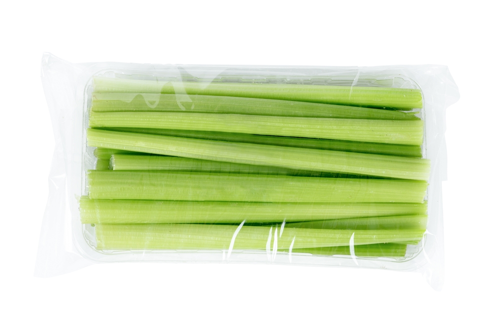 Freshly harvested celery stalk on isolated white background