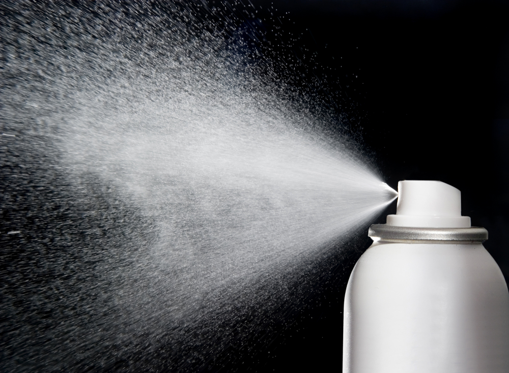 spray aerosol on black background