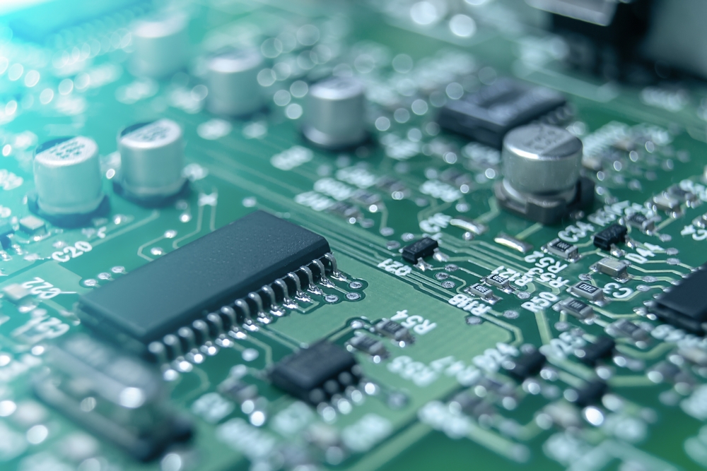 Closeup of Printed Circuit Board with processor, integrated circuits and many other surface mounted passive electrical components.
